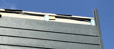 Cladding to flat roof parapet.