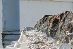 Guttering blocked by flat roof chippings