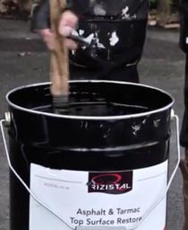 Stirring a can of tarmac restorer