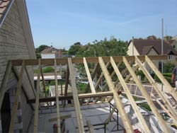 Roof trusses in a traditional roof showing trimming out for roof window