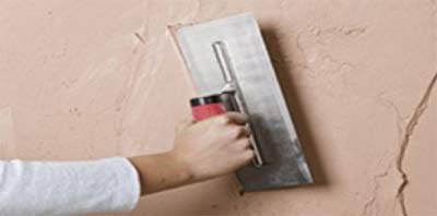 Applying plaster to a wall