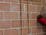 Cutting and Filling Chases in Brick and Concrete Walls for Wiring and Cables and Filling for Plastering