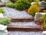 landscaped garden with shingle pathways