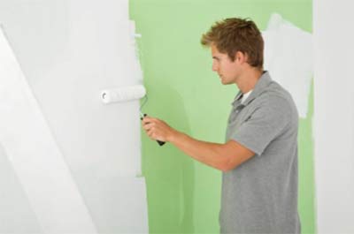 Painting a wall with a paint roller