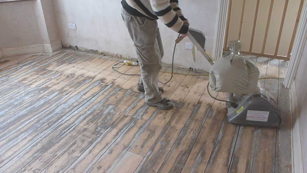 Sanding A Timber Floor Using A Floor Sander On Wooden Flooring