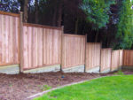 Stepped fencing to sloping ground.