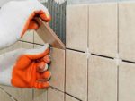 Laying tiles on a wall