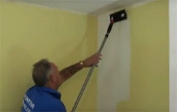 Using a paint pad to paint a wall