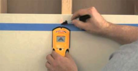 Using a stud detector to detect timber studs in walls