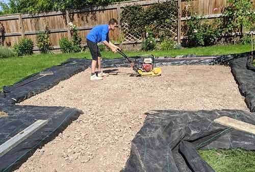 Compacting down Type 1 MOT sub base of driveway using a vibrating or whacker plate