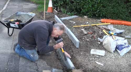 Lay edging stones in trench and level up