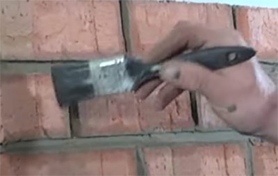 Brushing over mortar joint to close up surface