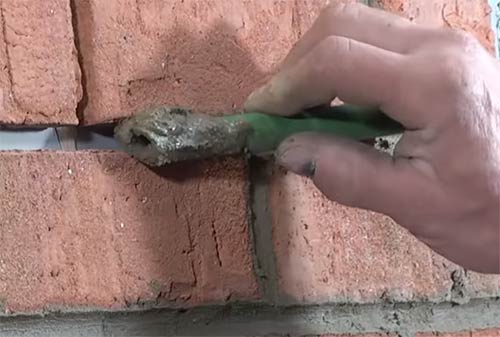 Finishing mortar joint using section of hose pipe