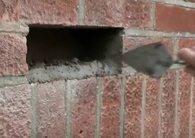 Mortar applied to sides of hole