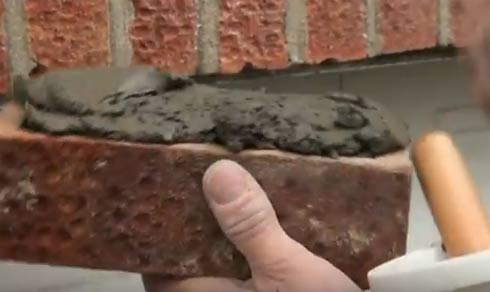 Mortar applied to top of replacement brick