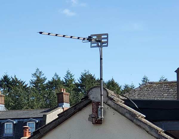 Standard outdoor TV aerial on side of house