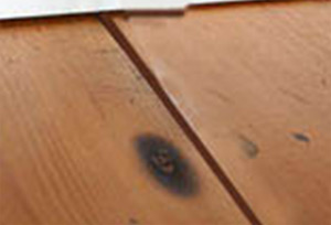 Gaps between wooden floorboards