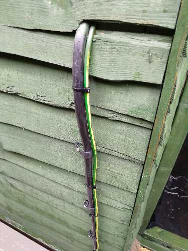 Armoured cable running into outbuilding