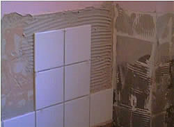 Laying tiles on wall