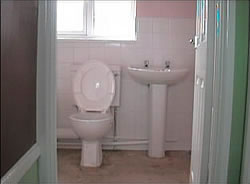 Completed bathroom install - sink and toilet installed and wall grouting completed