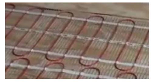 Electric underfloor heating mat installed over a floor