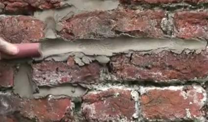 Pointing mortar joints with a piece of hosepipe