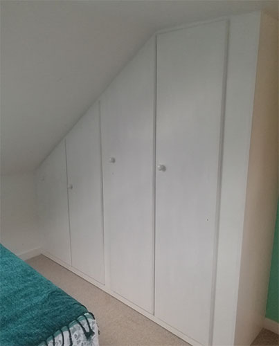 Finished and painted built-in sloping ceiling wardrobe