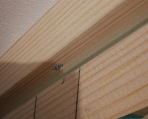 Front edge sloping timber fixed to ceiling