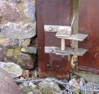 Gate hinge chemically fixed