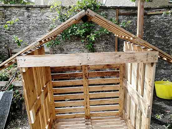 Chicken coop roof positioned in place on framework