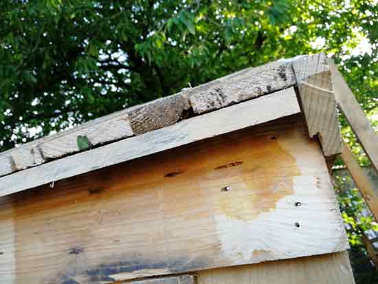 Fixing a slat to the underside of the roof overhang