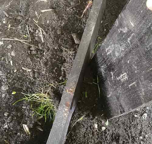 Backfilling and tamping down soil in trench