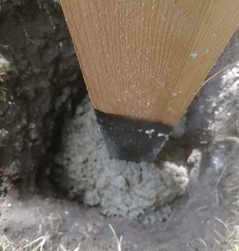 Cement added to fence post hole