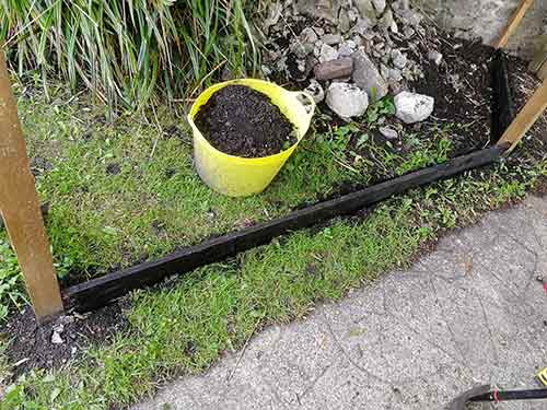 Middle gravel board fixed between fence posts