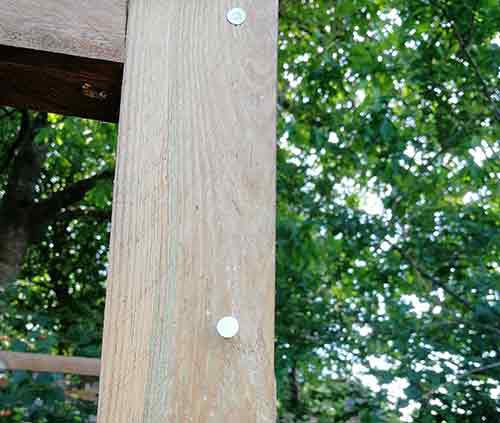 Nails hammered into post to hang wire