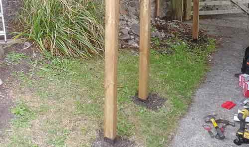 Soil added over fence post concrete