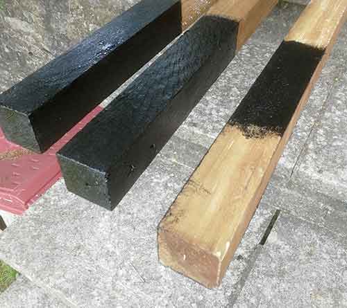 Fence posts treated with bitumen paint