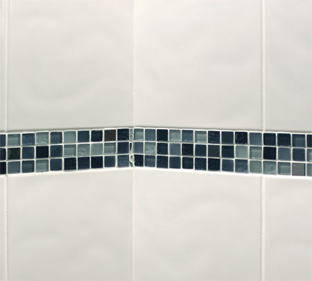 White tiled wall with border