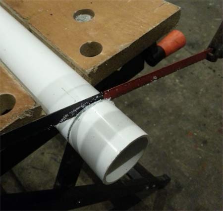 Cutting plastic pipe with a hacksaw