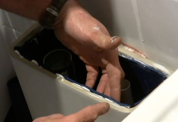 Sticking mat in place on inside of toilet using sealant