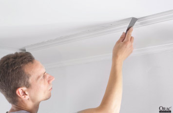 Remove excess adhesive from the edge of the coving