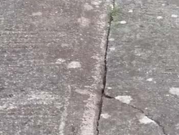 Crack in concrete path caused by bad joint