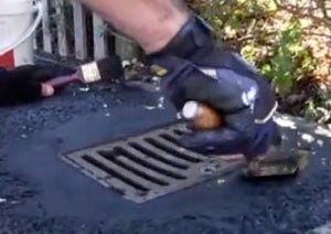 Tarmac repairs round drain gulley in driveway