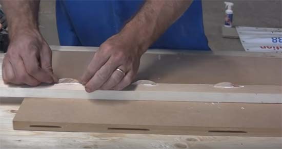 Applying glue to biscuit holes and timber faces