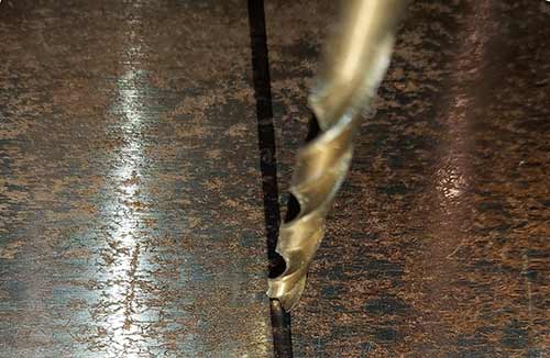 Cutting sheet metal using a drill