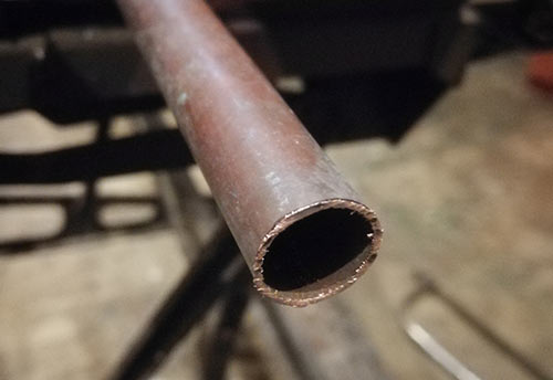 Burrs left on copper pipe after cutting with hacksaw