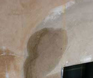 White hygroscopic salt staining on a chimney breast