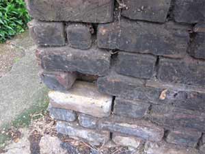 Brick wall with mortar joints missing