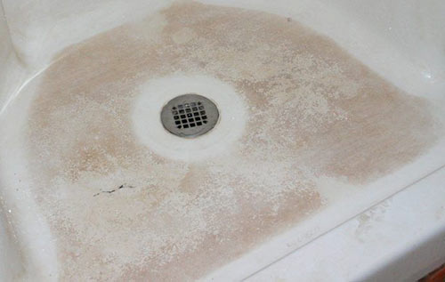 Soap scum deposits left around bath