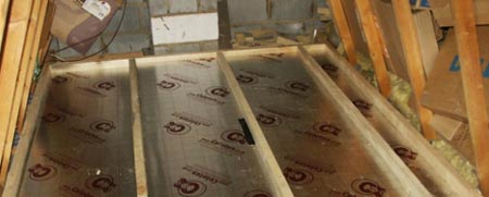 Insulation boards laid between joists